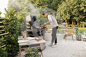 Man cooking on a grill outdoors