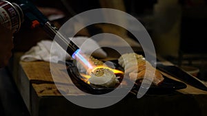 Man cooking in japanese restaurant with blowtorch for make sushi caramelize