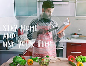 Man cooking at kitchen with book