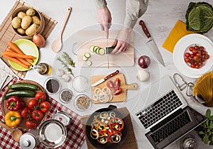 Man cooking with laptop