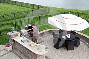 Man cooking meat on a gas BBQ