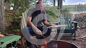 A Man Cooking Over Camp Fire