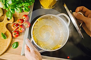 Man cooking pasta in boiling water