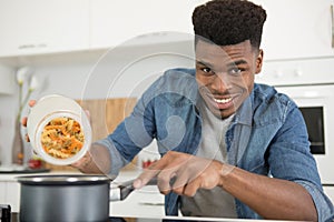 man cooking pasta at home