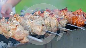 Man is cooking pork barbecue outdoors