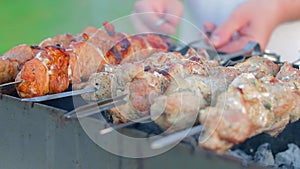 Man is Cooking Pork Barbecue Outdoors