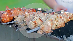 Man is Cooking Pork Barbecue Outdoors