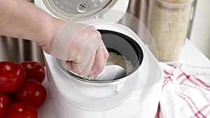 man cooking rice using Electric rice cooker