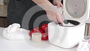 man cooking rice using Electric rice cooker