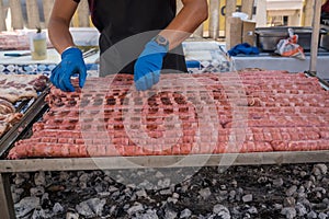 Man cooking sausage on grill