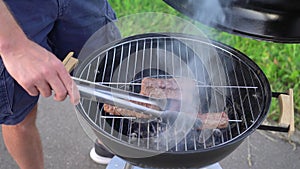 Man cooking sausages on the grill