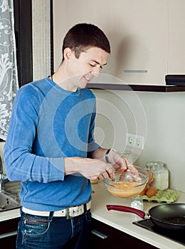 Man cooking scrambled eggs