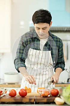 Man cooking with vegetables in kitchen