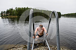 Man cooling down at water after taking sauna