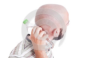 Man cooling his back neck with cold water bottle