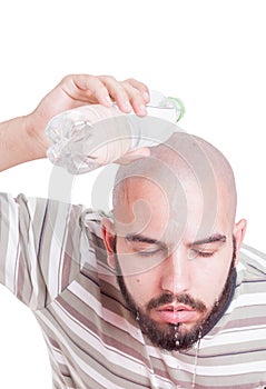 Man cooling by pouring water over head in summer heat