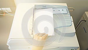 Man copying paper from Photocopier sunlight from window