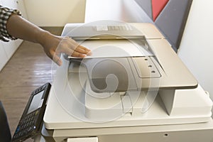 Man copying paper from Photocopier sunlight from window