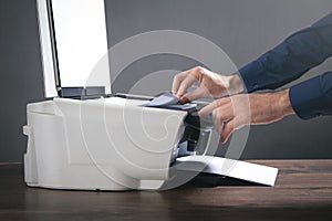Man copying and scanning documents in office