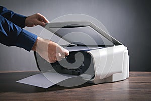 Man copying and scanning documents in office