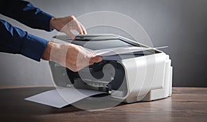 Man copying and scanning documents in office