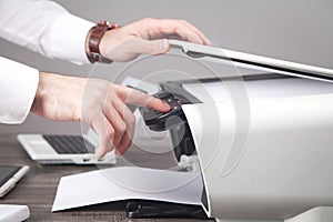 Man copying and scanning documents in office