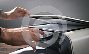 Man copying and scanning documents in office