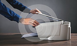 Man copying and scanning documents in office