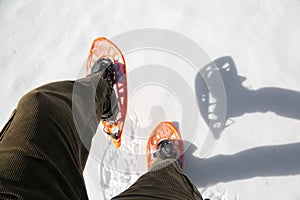 Man with corduroy trousers with snowshoes