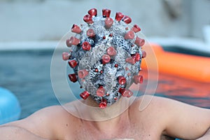 Man with coronavirus mask in swimming pool