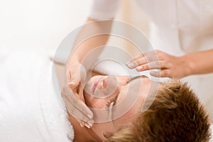 Man cosmetics - facial massage in salon