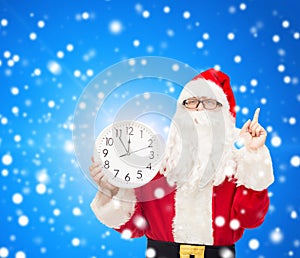 Man in costume of santa claus with clock