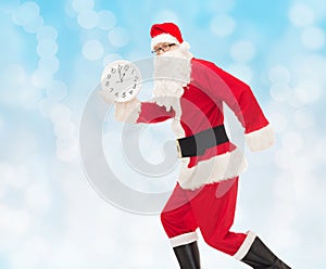 Man in costume of santa claus with clock