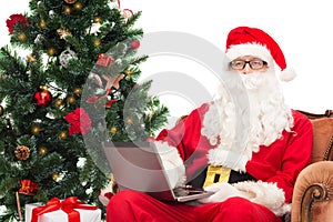 Man in costume of santa claus with laptop