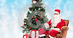 Man in costume of santa claus with laptop