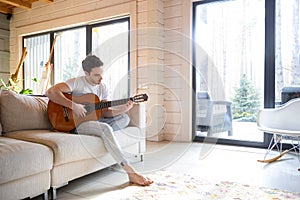 Man on couch with guitar