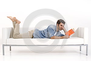Man on the couch reading a book