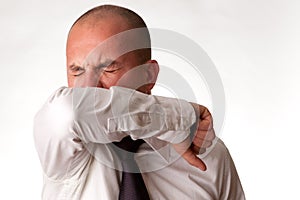 Man Coughing into Elbow