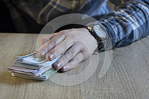 Man count money cash in his hand. Finance, saving, salary and donate concept