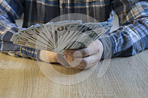 Man count money cash in his hand. Finance, saving, salary and donate concept