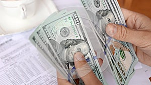 A man counting american dollar bills close-up