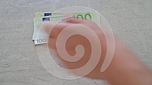 Man counting cash in 50 and 100 euro bank notes