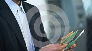 Man counting euros in bank branch, interest on deposit, profitable investment