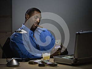 Man counting money at desk