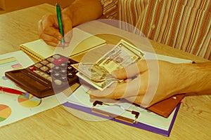 A man counting money. Savings, finances, economy, Business and home concept - Female with calculator counting money and making no