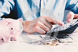 man counts money calculating finance