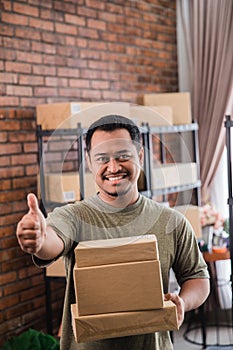 Man courier holding package work at shipping package business