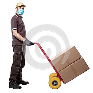 Man courier with mask uses a handtruck to transport packages photo