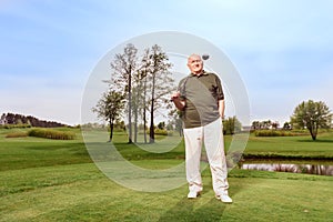 Man on course with golf club at shoulder