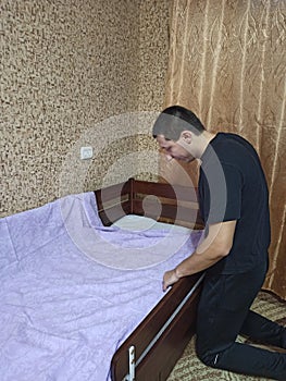 Man cover bedsheet on mattress on baby bed